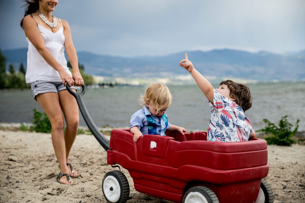 Victoria BC Family Photographer | family playing at the beach in a wagon