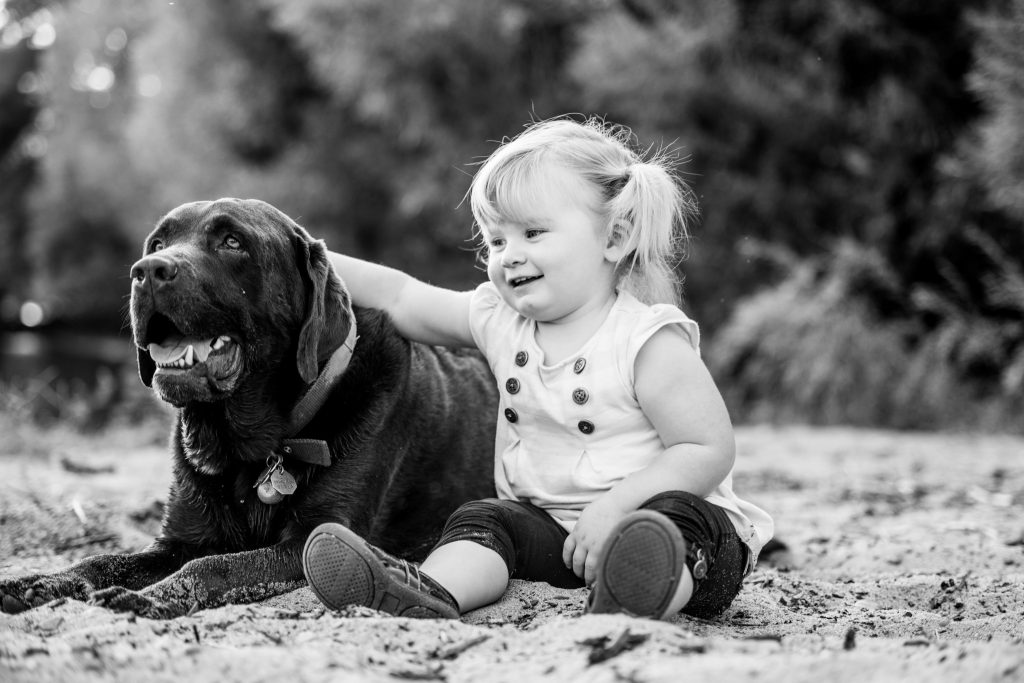 Victoria BC Family Photographer | toddler sitting with her dog at the beach