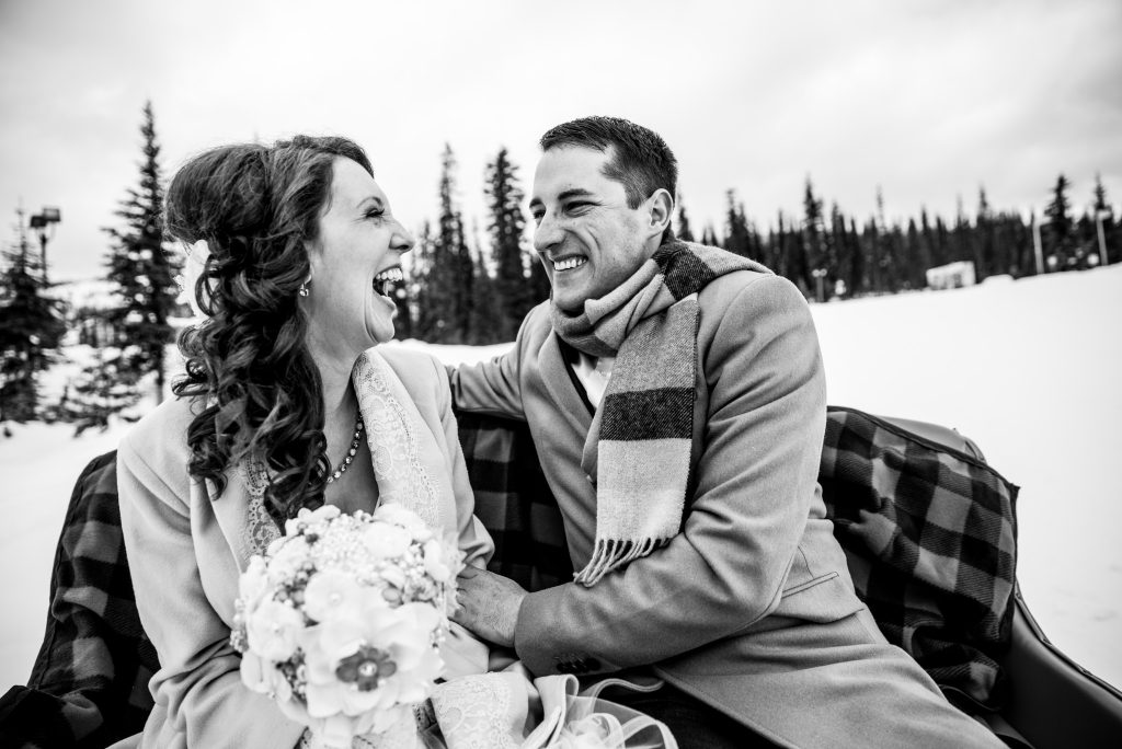 Stellavate Photography | Victoria BC wedding Photographer | Couple laugh on a horse drawn sleigh at big white
