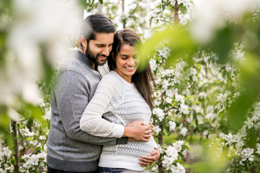 Victoria BC Family Photographer | pregnant couple embracing in an orchard