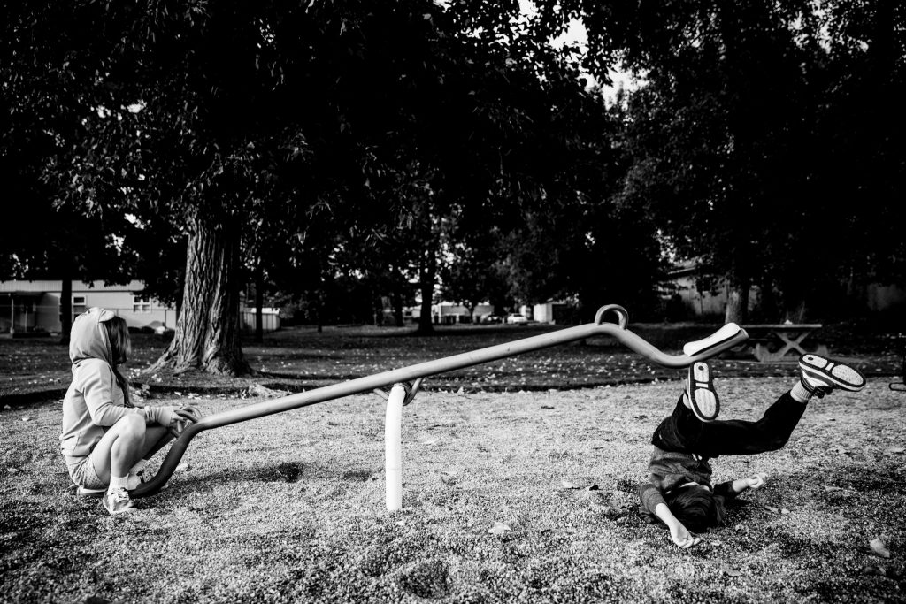 Victoria BC Family Photographer | child at the park on see-saw