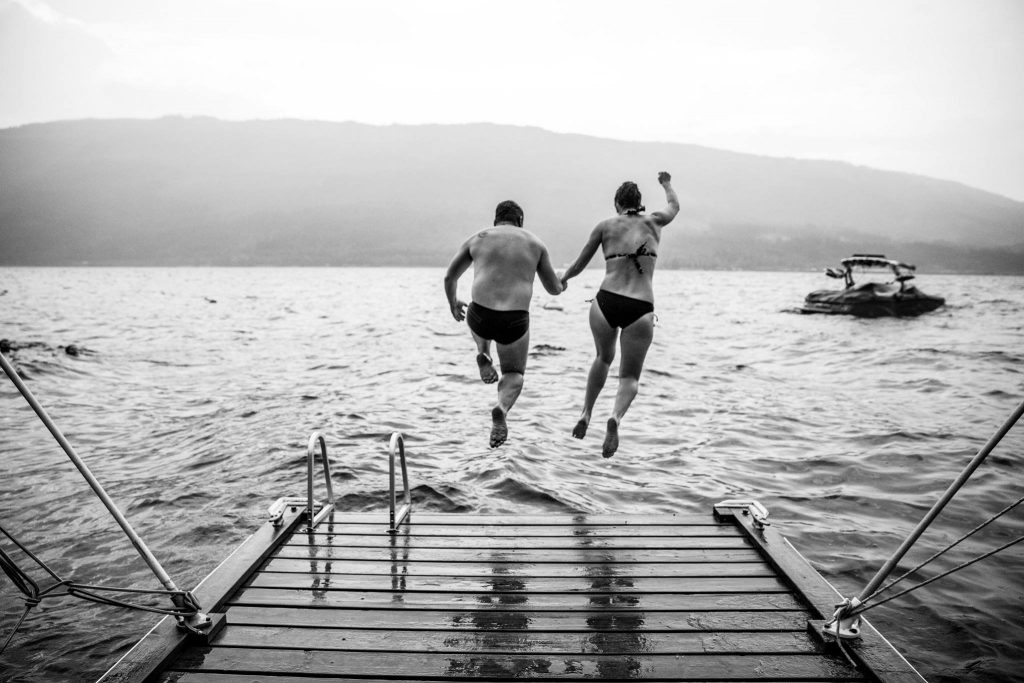 Stellavate Photography | Victoria BC wedding Photographer | Bride and groom jumping off a dock into the lake on their wedding day