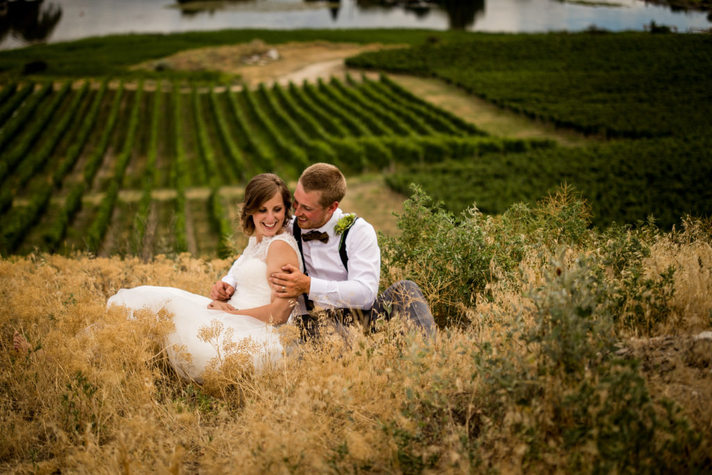 Stellavate Photography | Victoria BC wedding Photographer | Bride and groom sitting above rolling vineyard hills