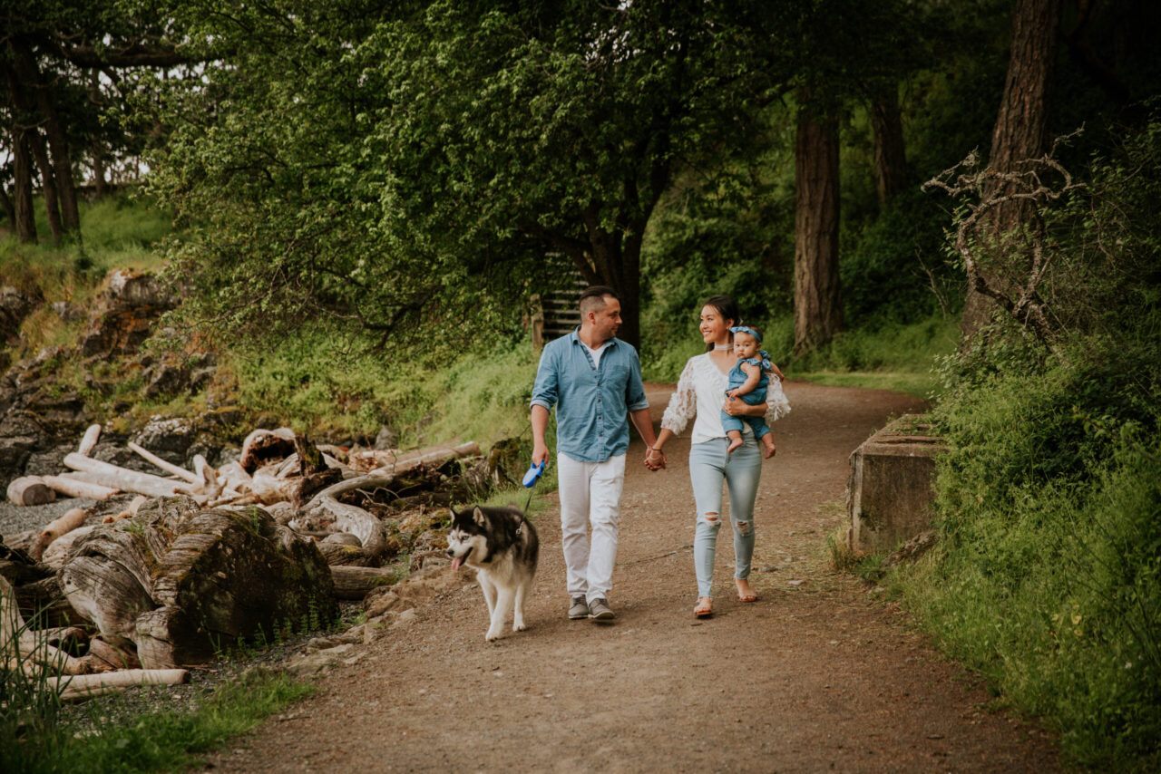 Victoria BC Family Photographer | family walking along the beach on vancouver island with dog and baby